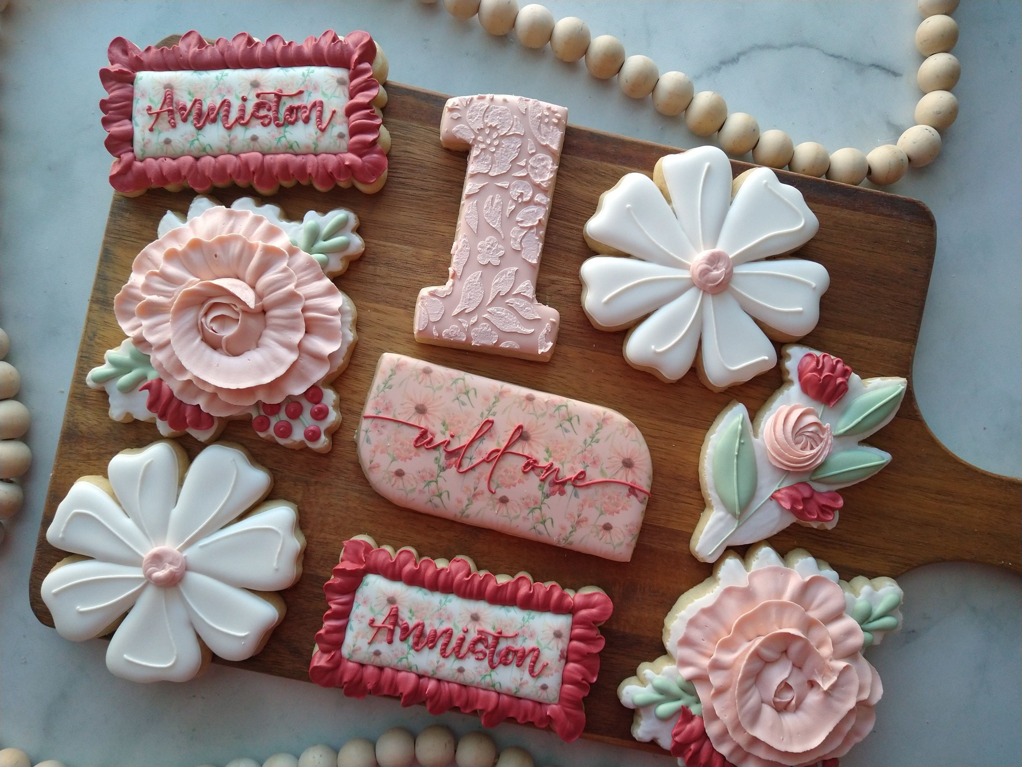 First birthday cookie set with florals, number one cookie, name cookies, and flowers