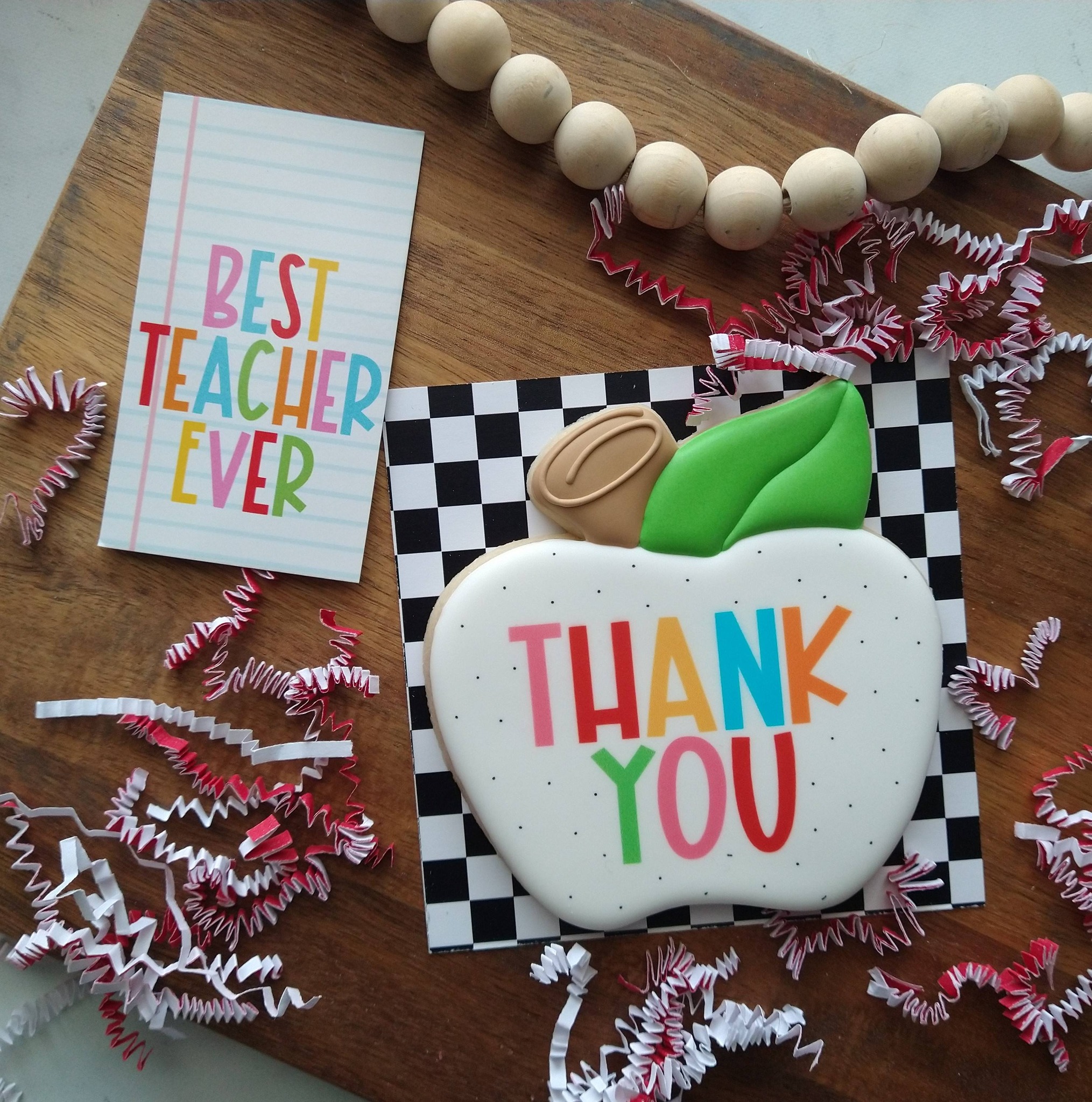 Teacher appreciation cookie with colorful thank you lettering and school-themed presentation
